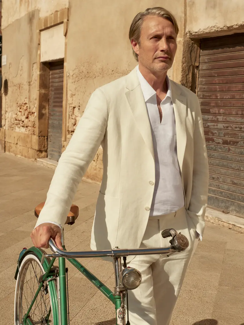Mads Mikkelsen wearing a tailored linen suit and leather loafers from the ZEGNA Spring/Summer 2025 collection.