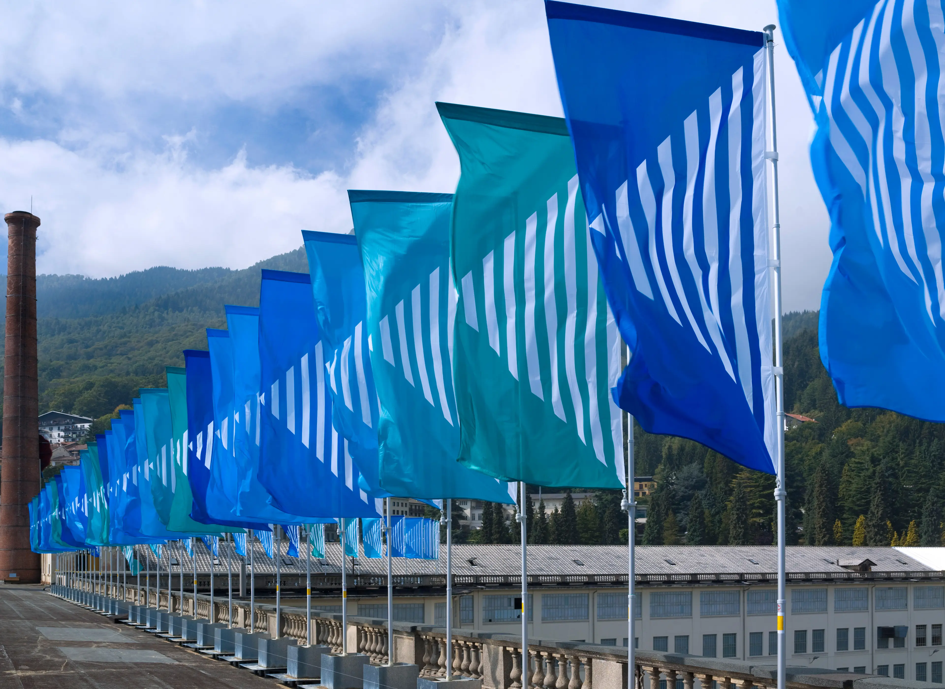 Outdoor installation of colorful wind vanes by Daniel Buren at Lanificio Zegna.