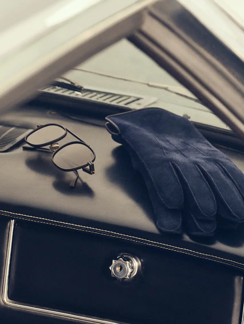 Close-up of ZEGNA gloves inside a sports car, Fall Winter 2025 collection.