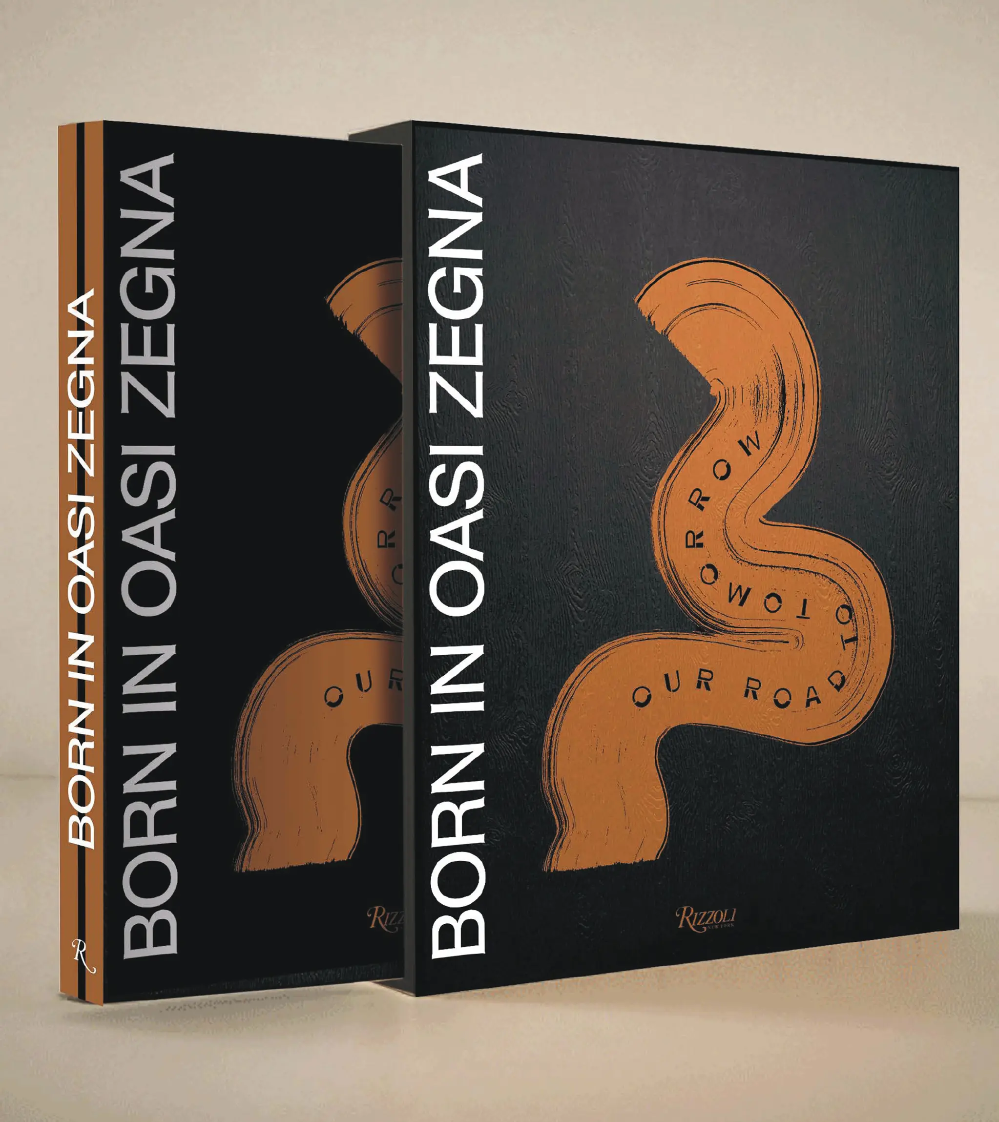 "Born in Oasi Zegna" book with black cover and orange symbol in the center.