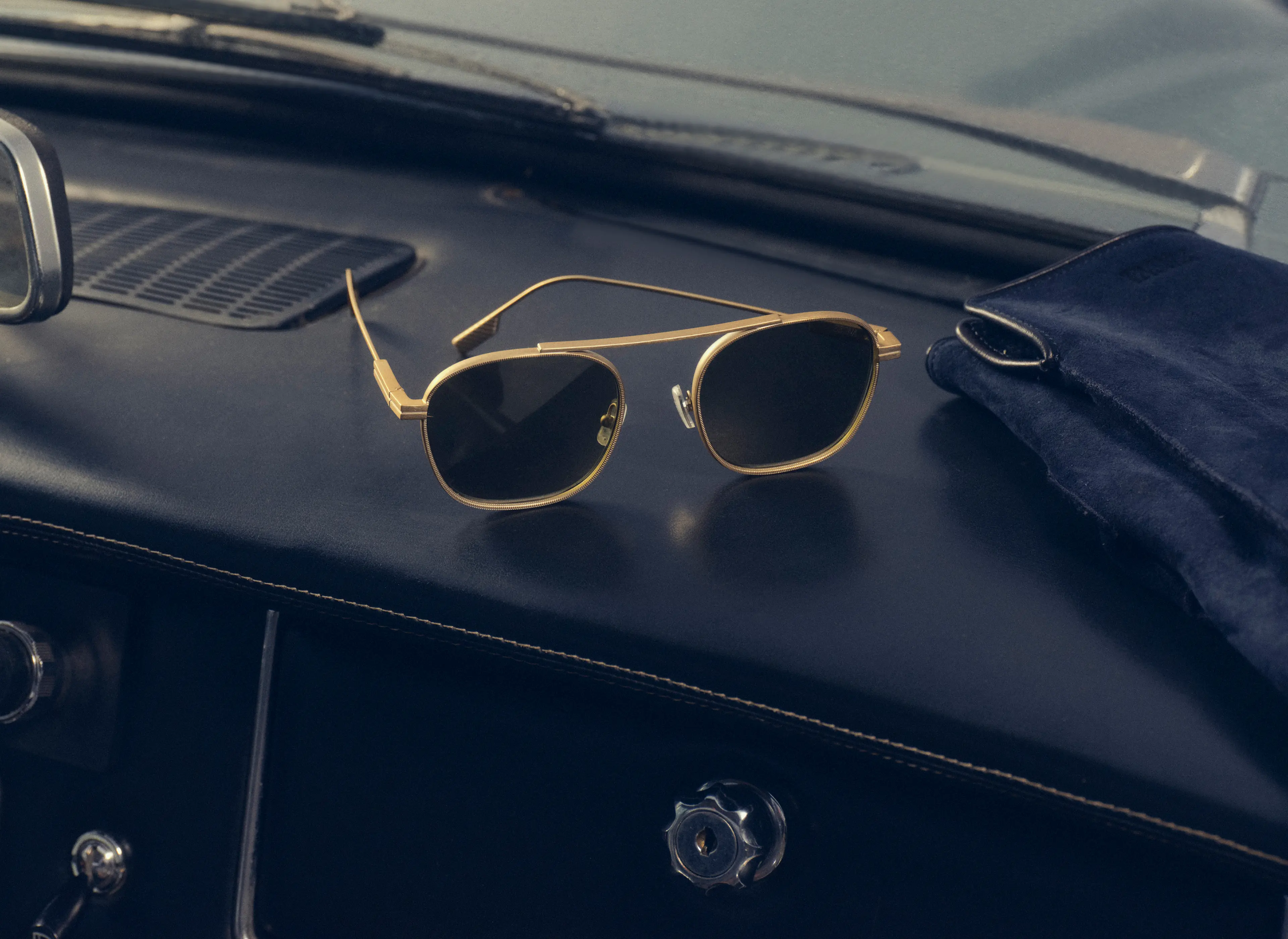 Close-up of ZEGNA sunglasses inside a sports car, Fall Winter 2025 collection.