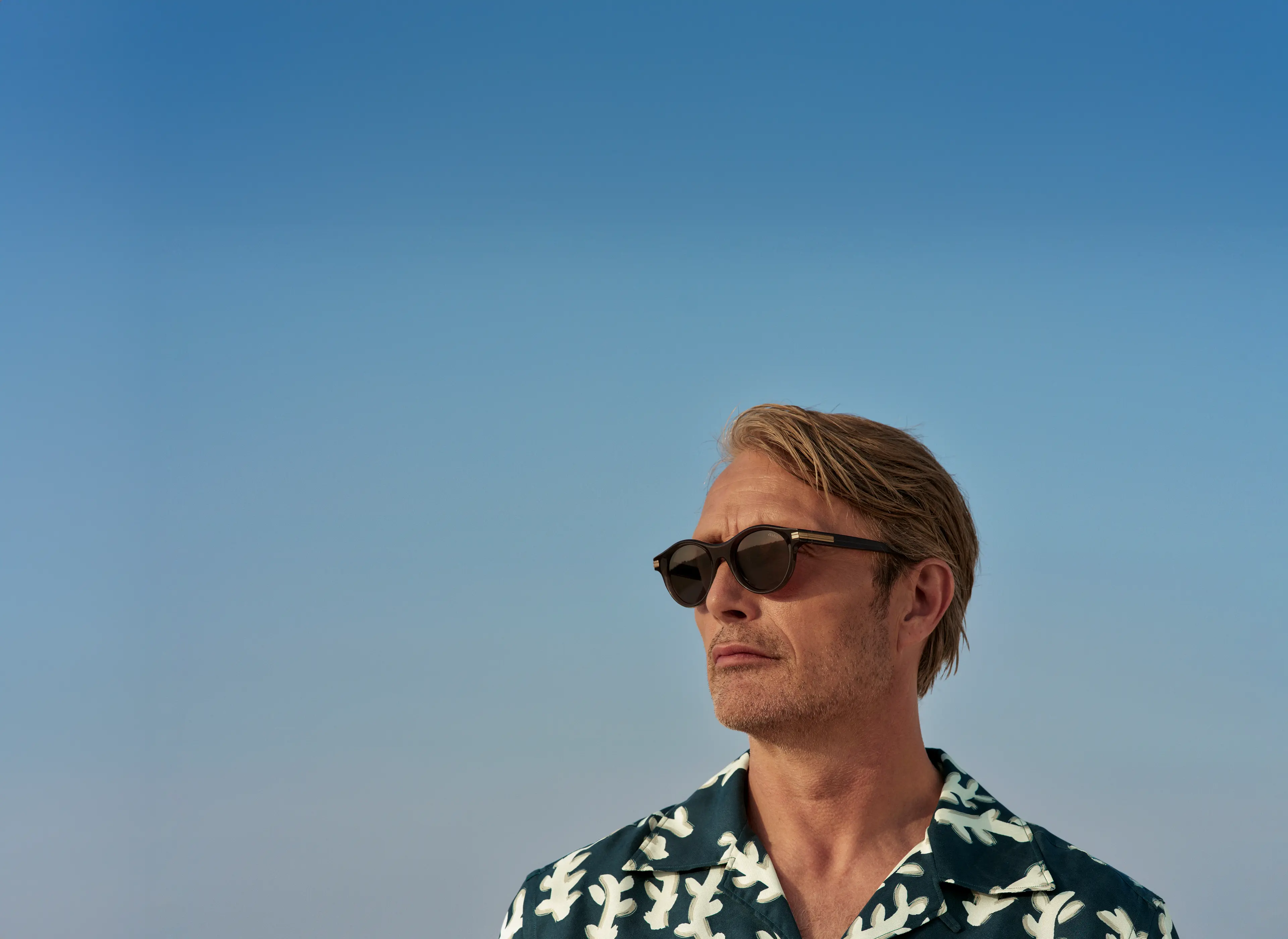 Mads Mikkelsen wearing acetate sunglasses and a shirt from the ZEGNA Spring/Summer 2025 collection.